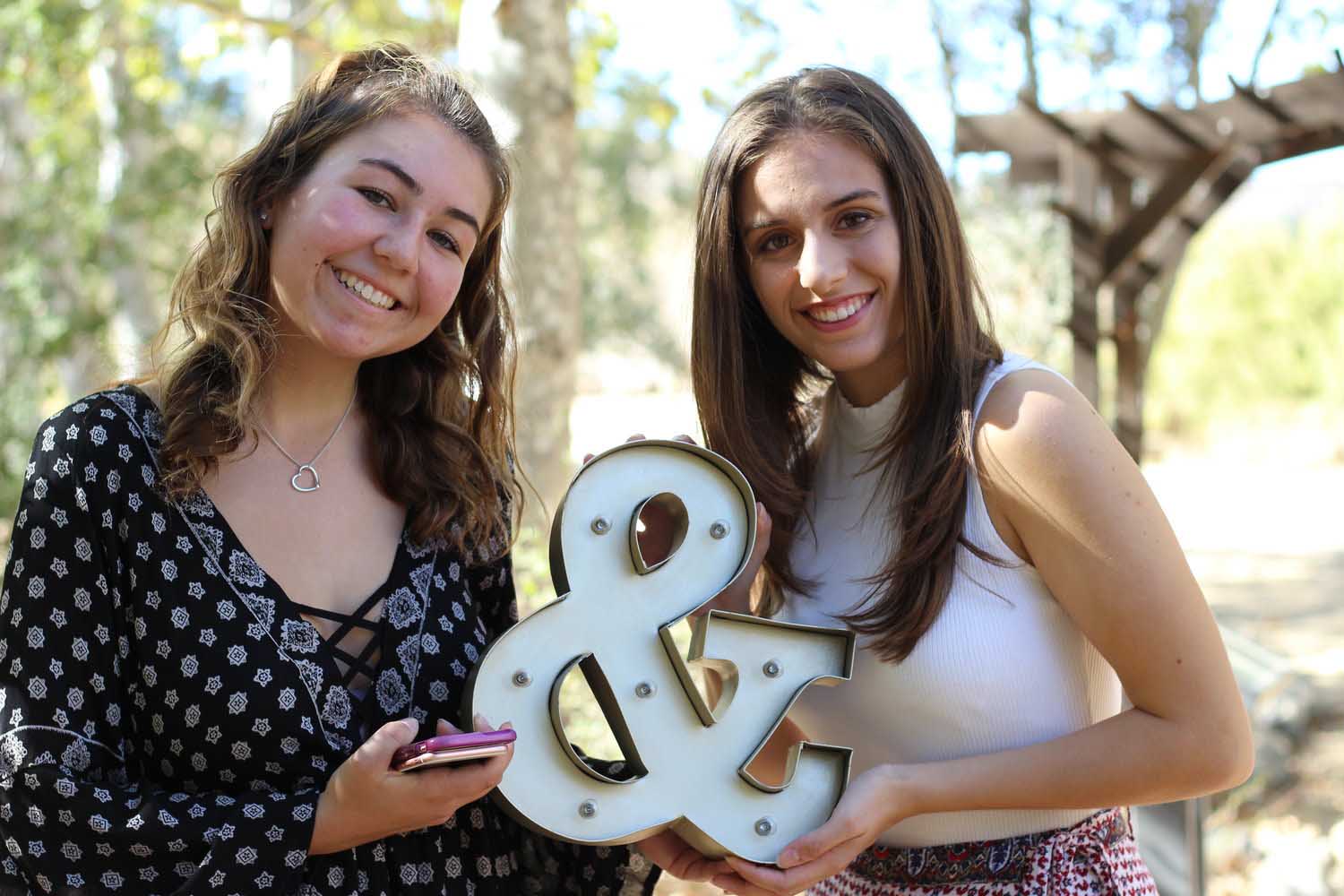 Seniors Alyssa Beamish and Dina Saccacio pose together as Ocampo's first portrait models.