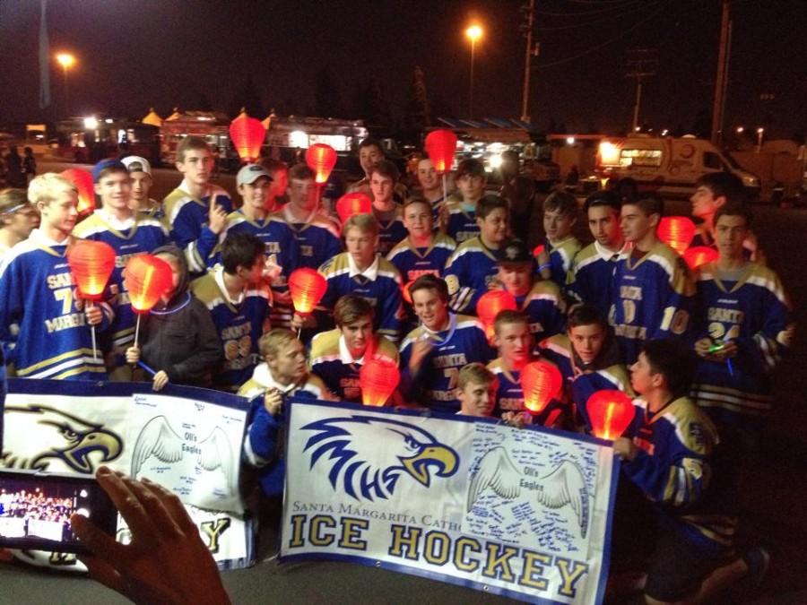 Ice Hockey poses with lanterns and banners before they start the Night the Light Walk at Angels Stadium. 
