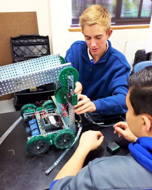 Consistent teamwork - Senior Ryan Dugan works with his group members to develop their robot and prepare for the competition.