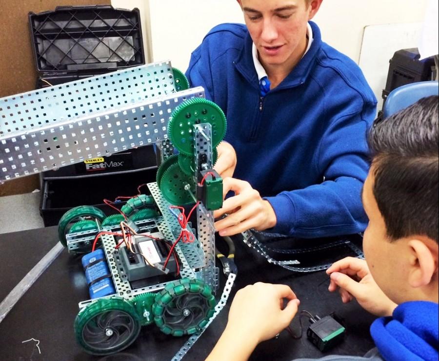 Consistent teamwork - Senior Ryan Dugan works with his group members to develop their robot and prepare for the competition.