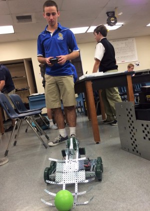 Practice makes perfect - Junior Mason Fredenburgh practices with the mobility of his robot to become faster in picking up objects. 