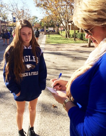 Caught in the act - Dean Jill Hegna demonstrates a detention-worthy dress code offense with an SMCHS student.