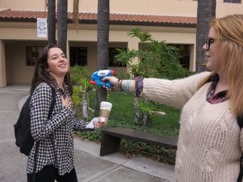 Gotcha - Senior Shannon Rice is squirted by senior Delaney Rosenthal in anticipation for Senior Assassin.