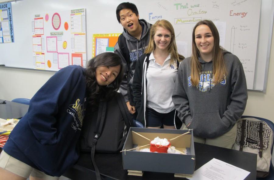 Eggcitement - Juniors Jennifer Tran, Brandon Kim, Danny Juergens and Nicole Walker, members of group three, are all smiles before testing their egg contraption. Their contraption was not enough to save the egg, however.