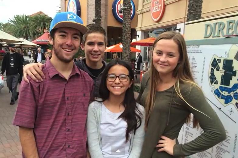 Senior Katie McLaughlin (right) poses with random people she met at the mall during her breaking social norms project. 