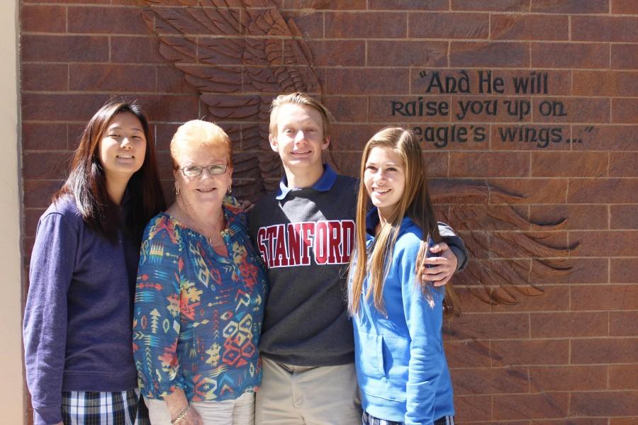 Eagle family - Seniors Yvonne Kim, Daniel Semeniuta and Katie Roschak pose for a picture with their two-year full-IB counselor Lyn Alexander.