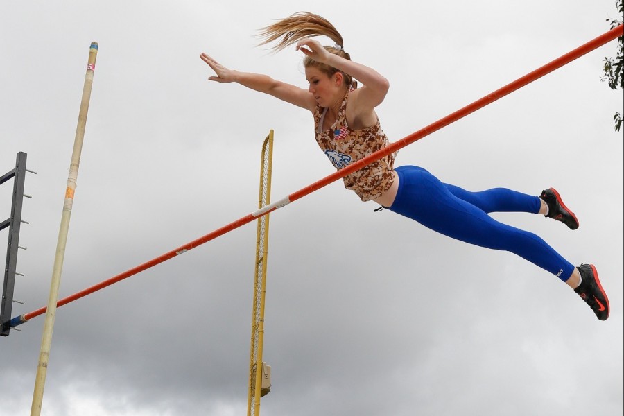 Overhead flight ​- Sophomore Kathryn Thomas uses concentration and upper body strength to make the jump.