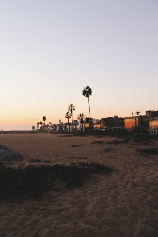 The sunset illuminates houses on the boardwalk at the Wedge.