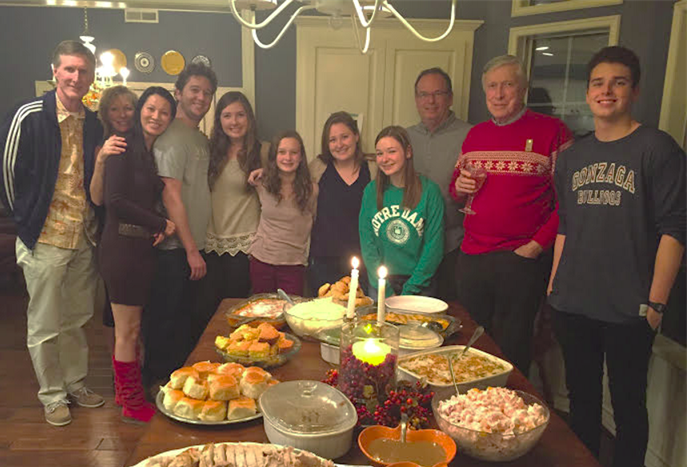 My family and I smiling for a photo before we devoured all of this food.