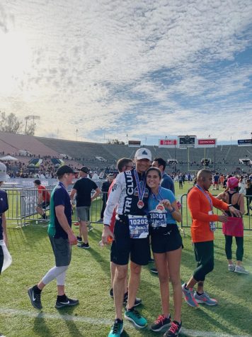 Sophia VonGierke and her dad stand in Rose Bowl stadium after finishing the Pasadena half marathon. They wear their medals of victory.