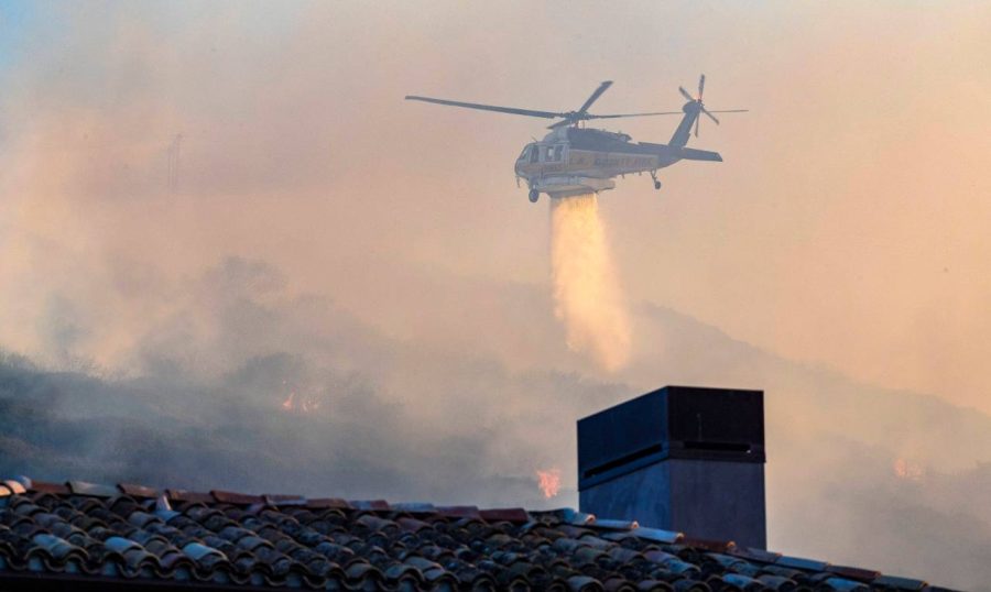 A+helicopter+rushes+to+help+contain+the+fire+by+dropping+water.+%28Photo+by+Orange+County+Register%29